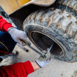 Close up on the fork lifter flat tire replacement